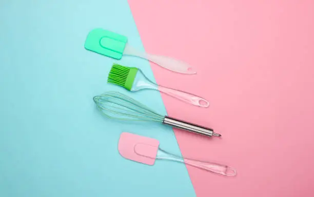 Flat lay compoisition of kitchen tools on pink blue pastel background. Minimalism. Top view