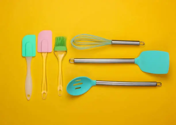 Flat lay compoisition of kitchen tools on yellow background. Minimalism. Top view