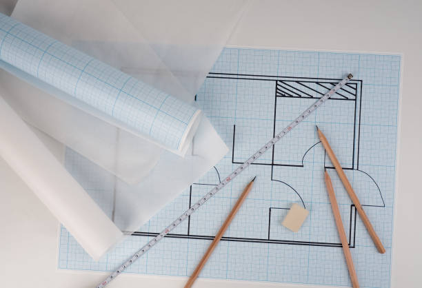 istock The projects of houses as a background, Architect workplace. Architectural project, blueprints, blueprint rolls on wooden desk table. Construction background. Engineering tools. Copy space 1225414827