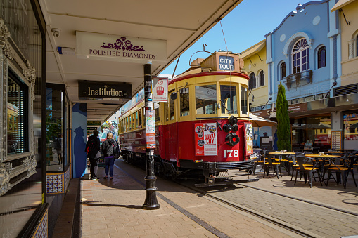 Tram and toursit in city centre, New Regent street, Christchurch, New Zealand.