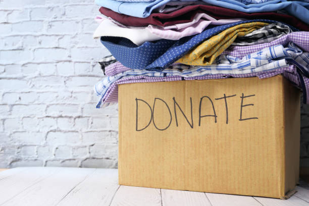 istock Donation box with donation clothes on a wooden table 1225416101