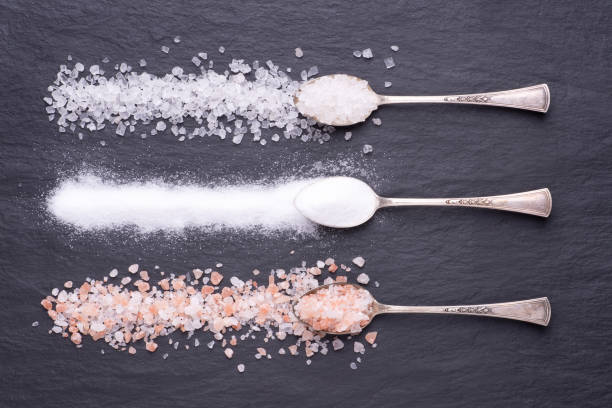 istock Various kinds of salt on black stone background 1225416322