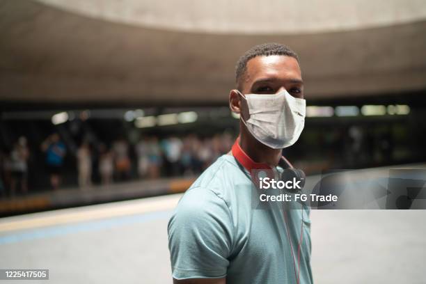 Portrait Of A Young Man Using Protective Mask At Metro Station Stock Photo - Download Image Now