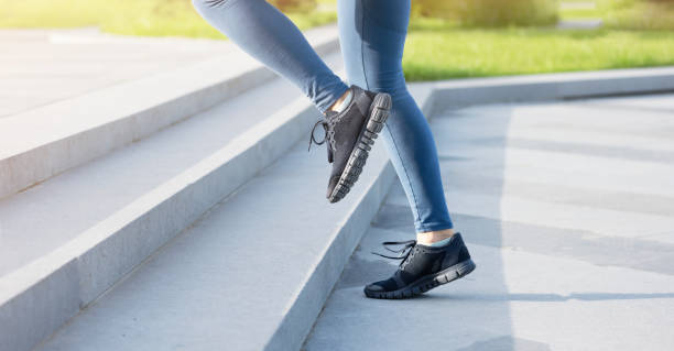 istock woman running up on stairs 1225417721