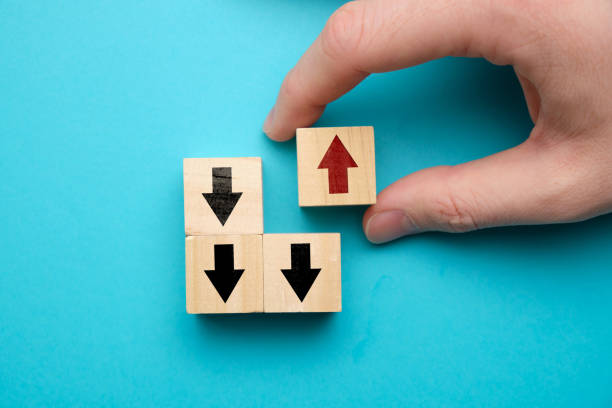 istock Alternative business development concept - hand holds wooden cube with red arrow. 1225418815