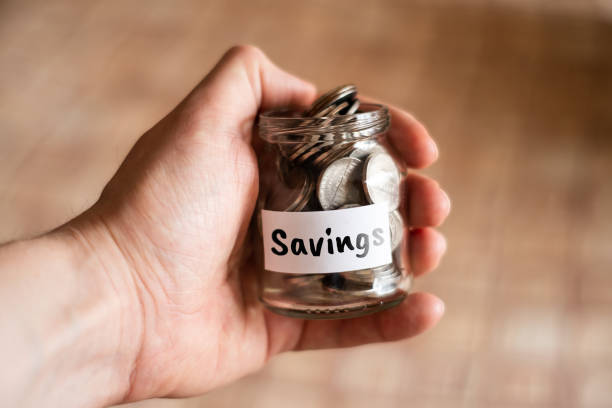 istock Money savings concept - glass jar with coins. 1225418901