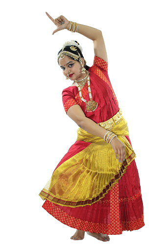 Beautiful young woman in a traditional costume performing Bharatanatyam, a classical dance form of India.