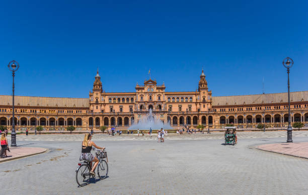 Woman riding a bicycle at the Plaza Espana in Sevilla stock photo