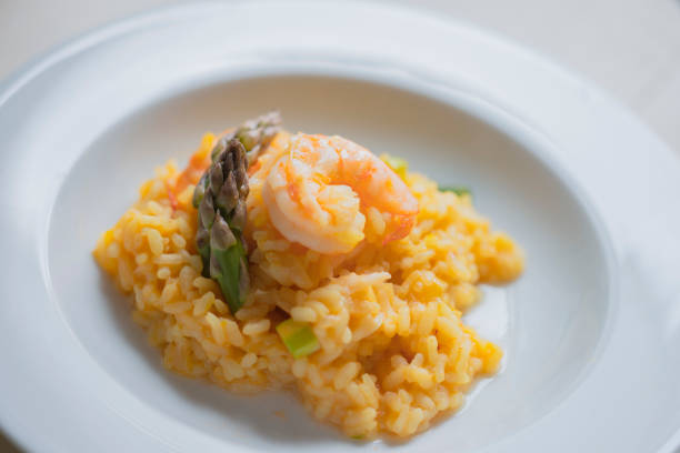 istock Risotto with asparagus and shrimps in plate 1225424084