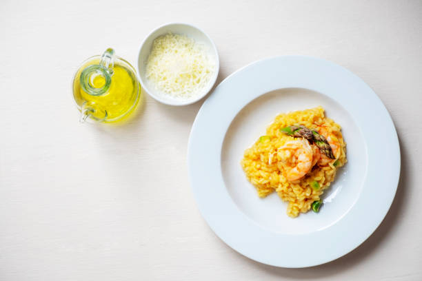 istock Risotto with asparagus and shrimps in plate 1225424097