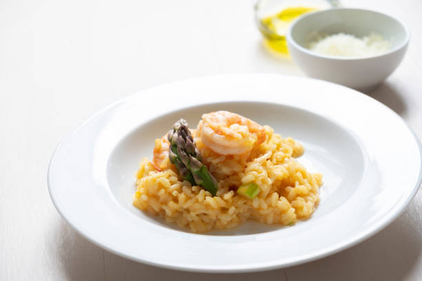 istock Risotto with asparagus and shrimps in plate 1225424247