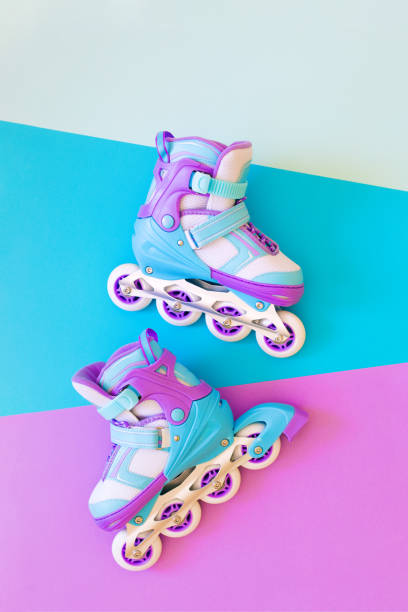 istock violet roller skates on blue and purple background. minimalism, flat lay, 1225427105