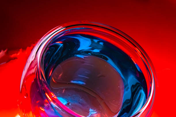 istock Fashionable double bottom cup with blue liquid on red backround. Concept art 1225428191