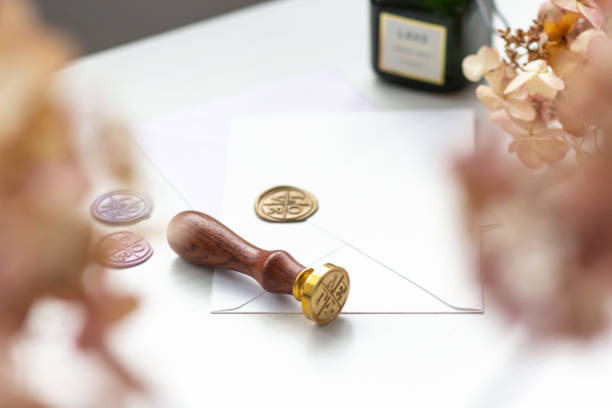 istock Stamp and envelopes on a light table with documents. Blur the leaves in the foreground 1225429949