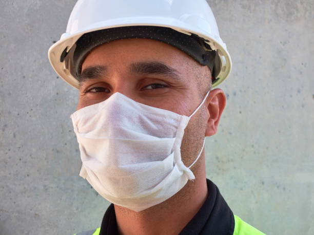 istock Civil engineer wears protective medical mask standing against concrete wall at construction site 1225430137