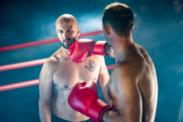 istock Man getting punched in the face by a boxer 1225430253