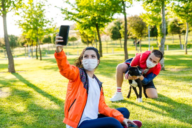 Young couple with dog in the park