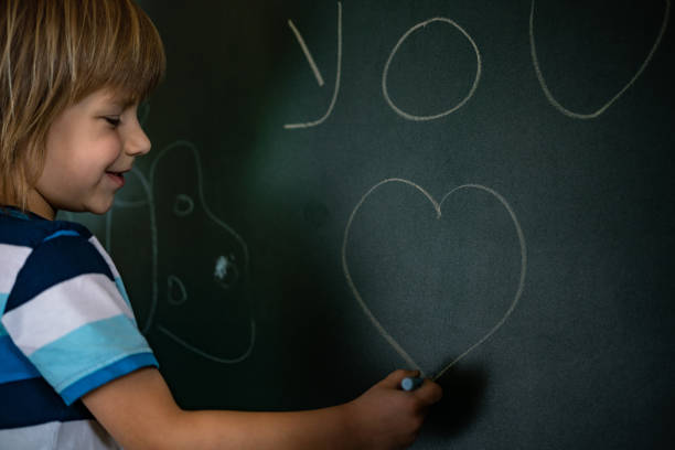 istock Cute boy drawing a heart at home during coronavirus 1225432445