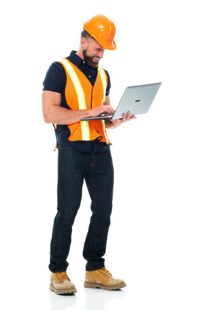 istock Repairman standing wearing button down shirt and holding hammer and using laptop 1225432525
