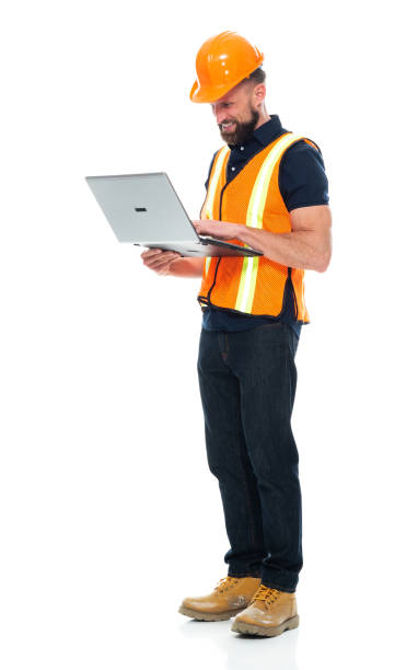 istock Technician standing wearing boot and holding hammer and using laptop 1225432593