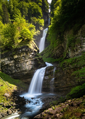 A view of the idyllic Diesbach creek waterfall in the Swiss Alps near Braunwald and Glarus in the spring