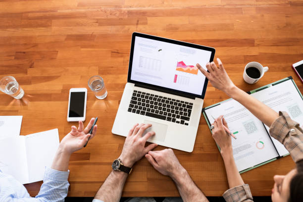 istock Team of Three Financial Experts Analyzing Reports on a Laptop 1225439238