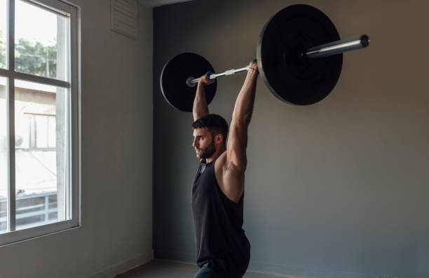 istock Weightlifting: a Strong Muscular Man Lifting  a Barbell 1225440096