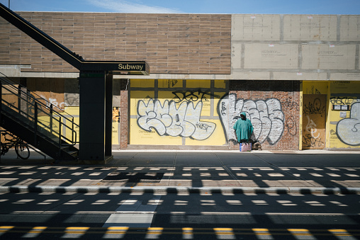 A homeless man stands outside Broadway subway station in Astoria, Queens. Queens is the largest borough in New York City and one of the hardest hit areas by COVID-19. Homeless and low-income people have been the most vulnerable populations during the pandemic.