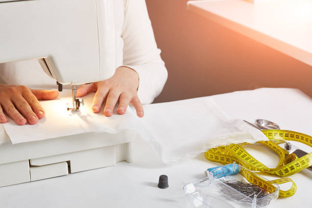 istock Women's hands sew on a sewing machine. Faceless. Copyspace 1225442550