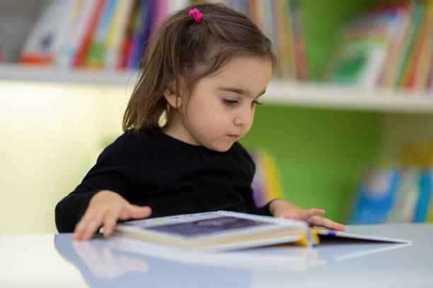 istock Little girl studying books 1225444851