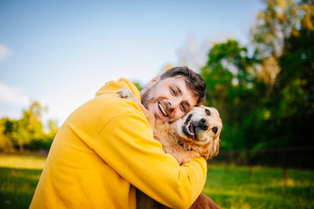 istock Young man having a fun with his dog in the nature 1225446026