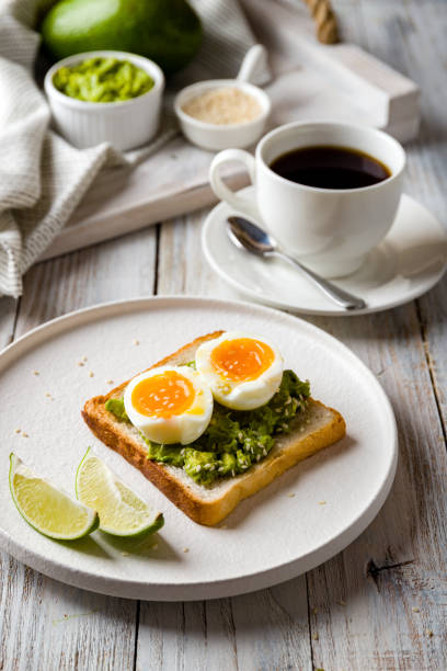 istock Toast with guacamole and boiled egg, avocado toast with coffee cup 1225446132