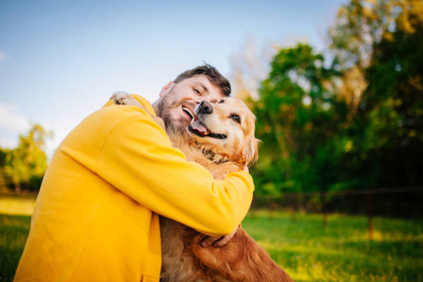 istock Young man having a fun with his dog in the nature 1225446144