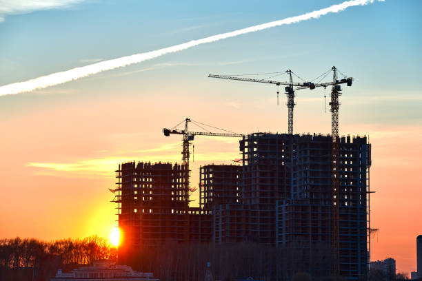istock Construction site at dusk evening yellow blue sunlight, back light, crane 1225449383