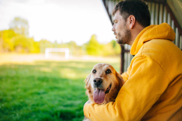 istock Young man having a fun with his dog in the nature 1225451616