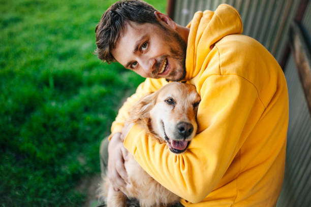 istock Young man having a fun with his dog in the nature 1225452522