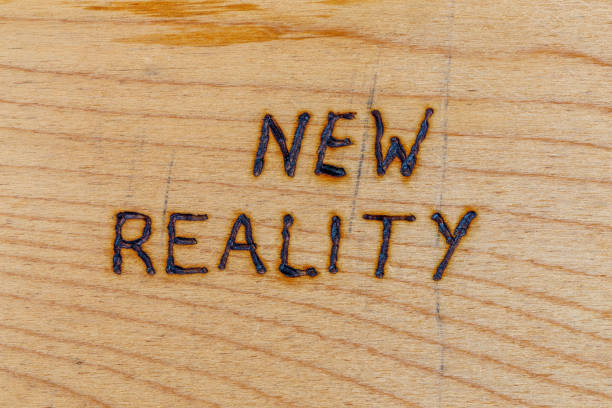 the words new reality handwritten with woodburner tool on flat wood surface - beginnings letter b planning letter a imagens e fotografias de stock