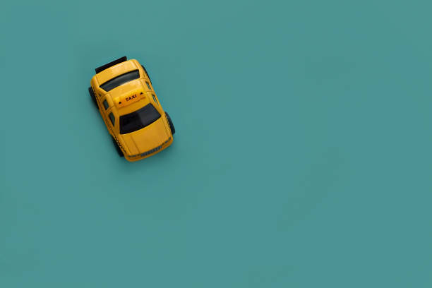 istock yellow taxi machine on green background with copy space, top view, flat lay 1225454561