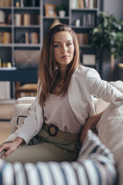 istock Woman sitting on sofa and looking at camera. 1225457914