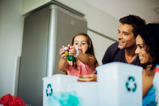 istock Happy couple collecting biodegradable waste with their daughter 1225458008
