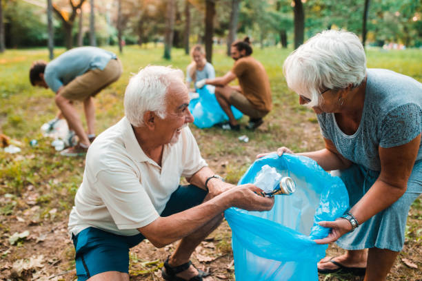 istock Senior couple cleaning up garbage for recycling 1225459062