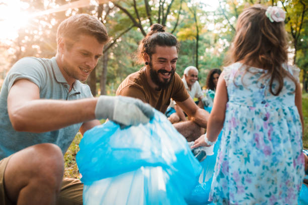istock Friends collecting garbage from the park with kids 1225459063