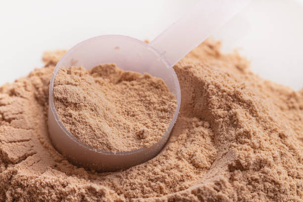 istock Chocolate flavor whey protein powder in close-up. 1225463280