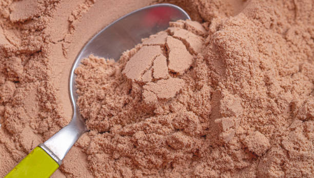istock Chocolate flavor whey protein powder in close-up. 1225463287
