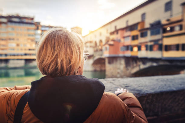 istock Tourist looking at Ponte Vecchio in Florence 1225464224