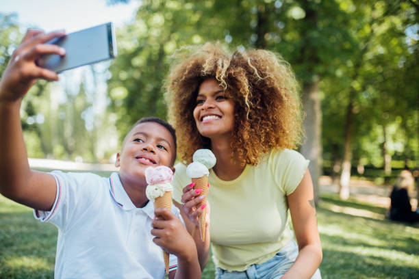 istock Boy and his mom eating ice cream and taking selfies 1225469495