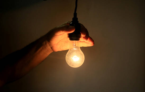 istock hands holding incandescent lamp 1225471563