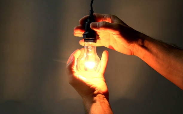 istock hands holding incandescent lamp 1225471586