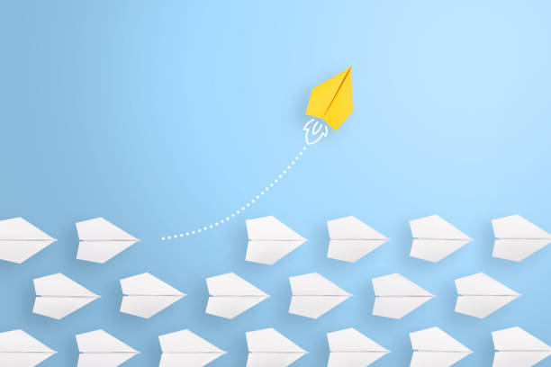 Change concepts with yellow paper airplane leading among white Change concepts with yellow paper airplane leading among white initiative photos stock pictures, royalty-free photos & images