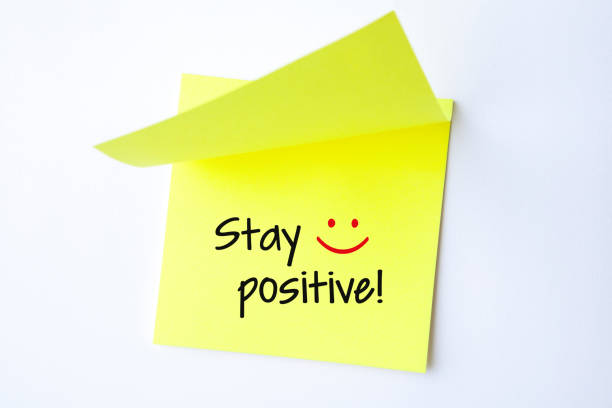 istock Yellow Sticky Note With Stay Positive And Red Push Pin On White Background 1225472413